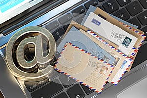 Email sign and letters on laptop keyboard. E-mail concept