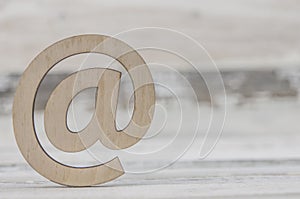 Email sign on a old white wood lies on a vintage wooden table. Concept e-mail message letter. Top view with copy space