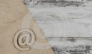 Email sign on a old white wood lies on a vintage wooden table. Concept e-mail message letter. Top view with copy space