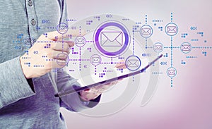 Emails with man holding a tablet