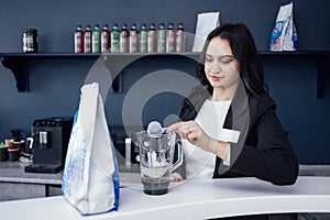 emale barista pours milkshake into glass with straw