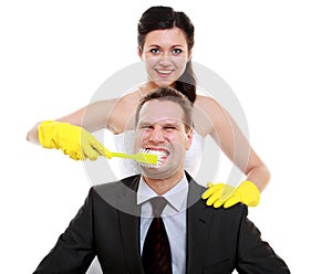 Emancipation idea. Woman brushing teeth of her man, humor