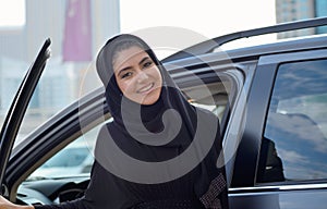 Emarati Arab Business woman getting inside the car