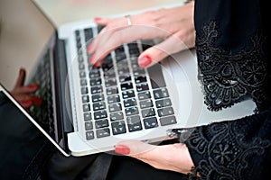Emarati Arab Business woman using laptop computer