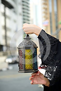 Emarati Arab woman holding Ramadan lantern