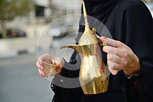 Emarati Arab woman pouring tea