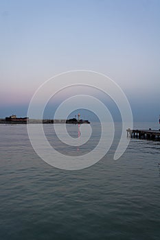 The embankment of the city of Yalta. The lighthouse and the sea.