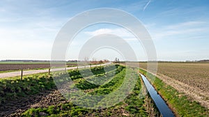 Embankment with country road between plowed fields