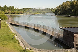 Embankment on lake. View of park. City Pond