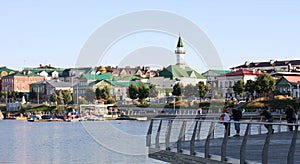 The embankment of the Lower Kaban Lake. Tourists are walking and boating. Photo with copy space. Panoramic view of the embankment