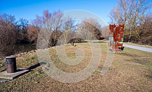 Embankment of the Morava River with rusty monument