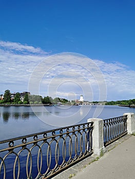 The embankment of the Salakka - Lahti Bay, in the distance the St. Olaf Tower in the Vyborg Castle in the city of Vyborg against