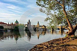 Embankment of the Vltava River with a view of the Charles Bridge in Prague, Czech Republic