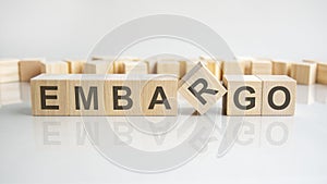 EMBARGO text on a wooden blocks, gray background