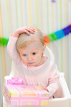 Embarrassed baby celebrating first birthday