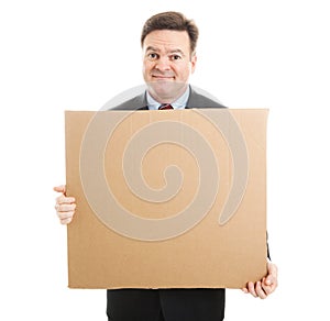 Embarrassed Businessman with Cardboard Sign photo