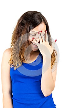 Embarrassed girl covers her face with palm photo