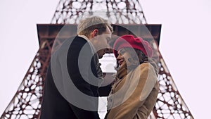 Embarrassed lovers kissing first time, romantic date in Paris, relationship