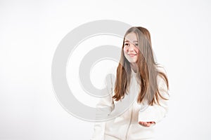 Embarrassed readhead girl in white hoodie looking at left side isolated over white background
