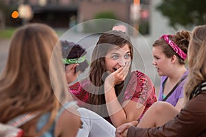 Embarrassed Teen with Hand on Mouth photo