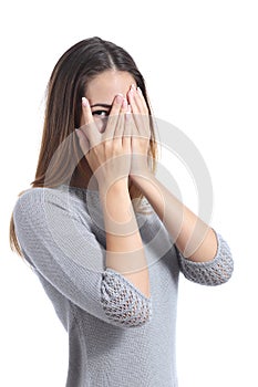 Embarrassed woman looking through her hands covering her face