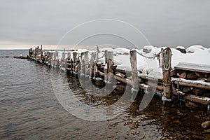 Embedded stones and harbor ruins in Juminda. Rocky beach, peaceful sea and port.