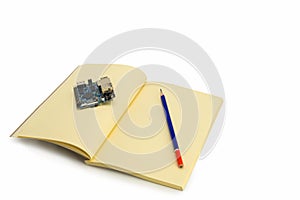 Embedded system development planning with notebook and pencil on white background