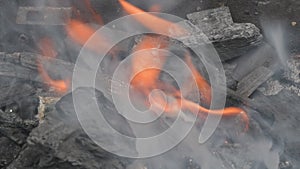 Embers glowing in blazing fire burning charcoal