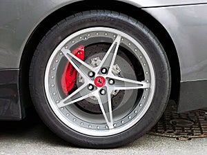 Kiev, Ukraine - 11 April; Emblem of Ferrari. Horse. Car wheels close up on a background of asphalt