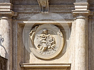 Emblem with mother and children in buliding in Rome photo