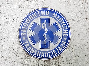 Emblem sign of round the clock emergency medical care in Poland, concept of an obsolete and ineffective medical system