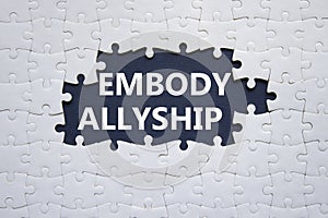 Embody Allyship symbol. Concept word Embody Allyship on white puzzle. Beautiful dark blue background. Business and Embody Allyship photo