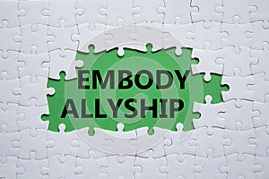 Embody Allyship symbol. Concept word Embody Allyship on white puzzle. Beautiful green background. Business and Embody Allyship photo