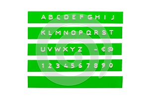 Embossed alphabet on green plastic tape