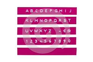 Embossed alphabet on purple plastic tape