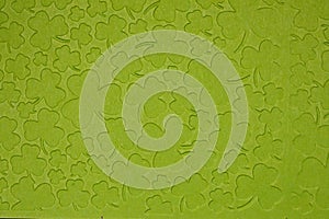 Embossed light green carton paper. Background of shamrock.