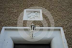 Embossed milling on the front wall of a house in the historic Siedlung Elsengrund complex. Kopenick, Berlin, Germany