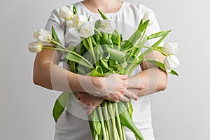Embrace of White Tulips Bouquet by Woman in White Tee. Greeting Postcard