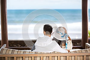 Embracing couple enjoying the view of the azure blue sea