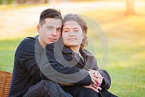 Embracing Hispanic Pregnant Young Couple Portrait Outdoors