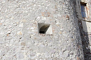Embrasure, loophole in the wall of an old mountain fortress photo