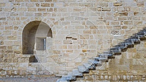An embrasure and a staircase on the stone wall of an ancient for photo