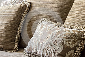 Embroidered elegant cushion in a couch.