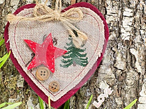 Embroidered heart on tree bark