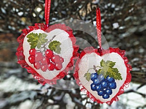 Embroidered hearts with viburnum and grap as Ukrainian symbols of man and woman ( photo