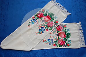 Embroidered towel on a blue background.