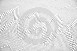 Embroidered white towel with geometric shapes photo