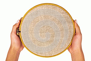 Embroidery hoop with natural linen fabric.