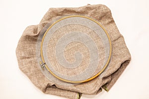 Embroidery hoop with natural linen fabric.