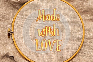 Embroidery hoop with natural linen fabric.